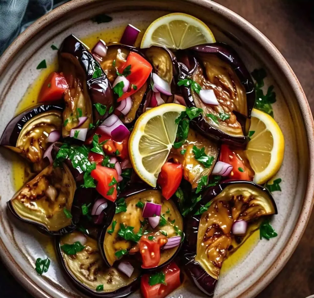 A fresh and colorful eggplant salad with tomatoes, onions, and herbs.
