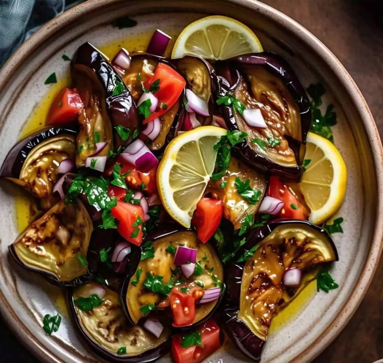 A fresh and colorful eggplant salad with tomatoes, onions, and herbs.