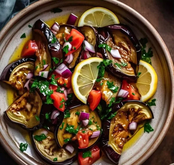 A fresh and colorful eggplant salad with tomatoes, onions, and herbs.