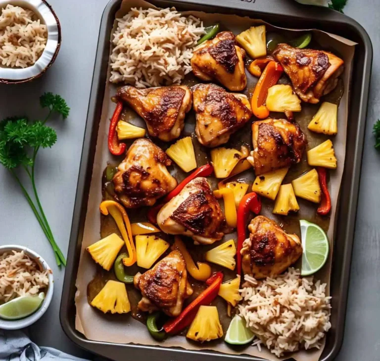 A vibrant Hawaiian Chicken Sheet Pan meal with pineapple, bell peppers, and chicken on a baking tray.